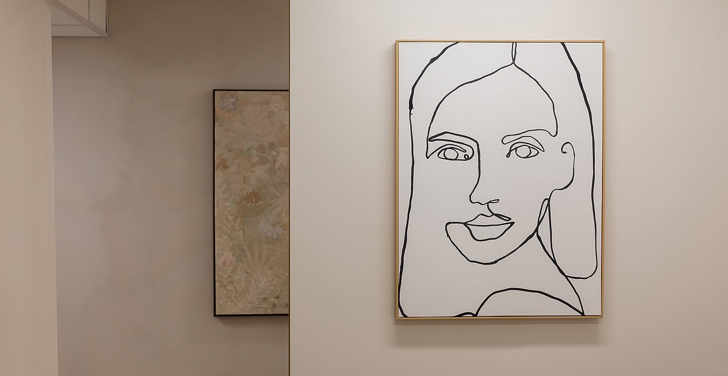 Line art portrait on wall in minimal setting