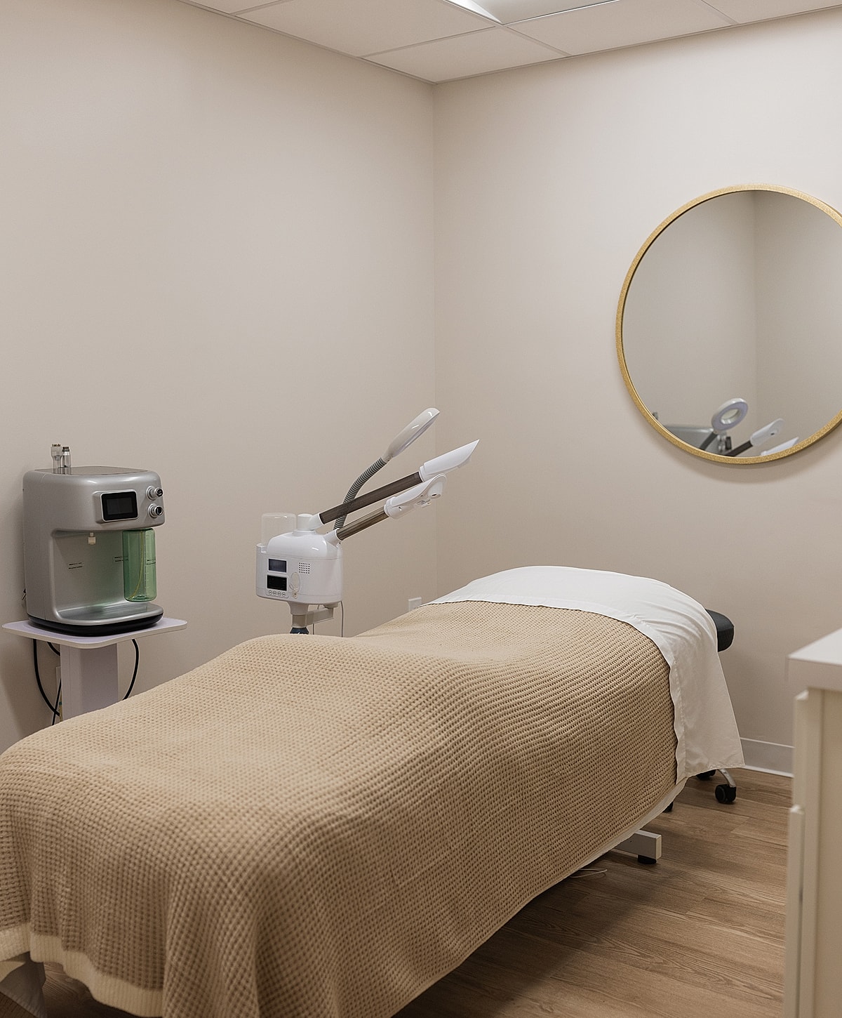Spa treatment room with massage table and equipment.
